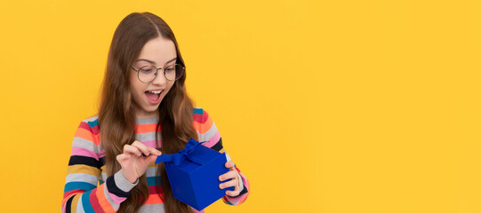 Child girl gift. surprised teen girl in eyeglasses open box. boxing day. present and gifts buy. Kid girl with gift, horizontal poster. Banner header with copy space.