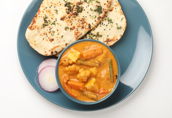 Mix vegetable curry - Indian main course recipe contains Carrots, cauliflower, green peas and beans capsicum and paneer with traditional   potato with roti or chappati  naan or Indian bread 