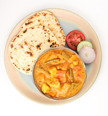 Mix vegetable curry - Indian main course recipe contains Carrots, cauliflower, green peas and beans capsicum and paneer with traditional   potato with roti or chappati  naan or Indian bread 