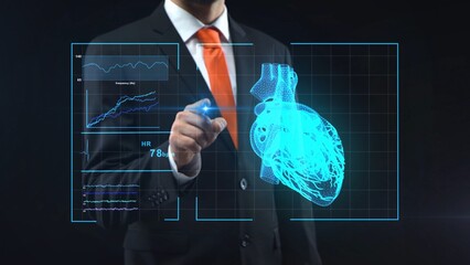 Man in black suit touching with a finger holographic interface with touch screen on technological medical digital monitor. Doctor looking on virtual hologram with heart. Diagnosis, treatment, research