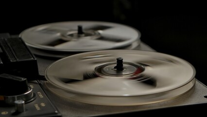 Vintage professional analog reel to reel tape recorder on black studio background. Transparent...