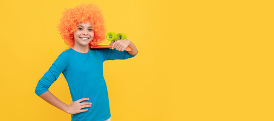 happy teen girl in fancy clown wig hold penny board, childhood. Funny teenager child on party, poster banner header with copy space.
