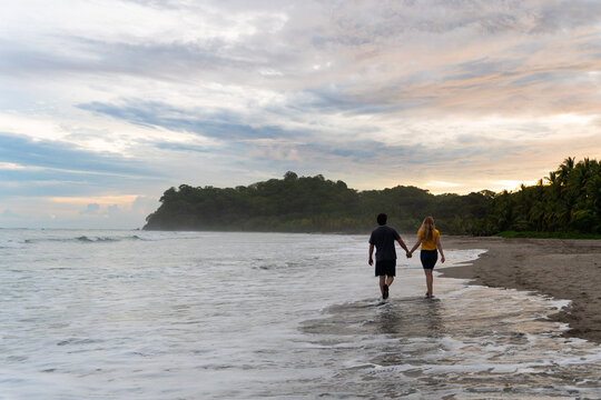 couple walking on the beach 