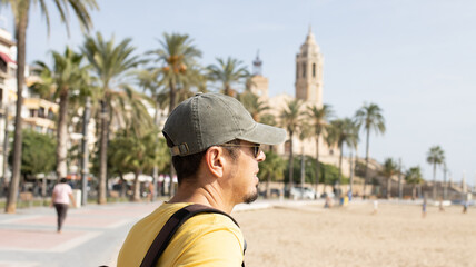 Colombian man with sunglasses on vacation in Sitges (Spain), selective approach to the cap, travel...