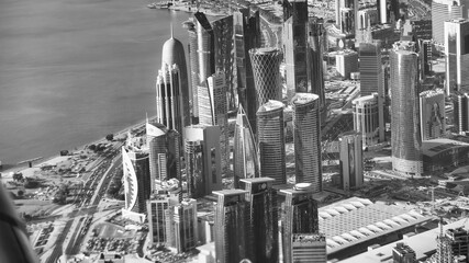 Doha, Qatar - December 12, 2016: Aerial view of city skyline from a flying airplane over the Qatar capital