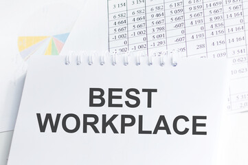 BEST WORKPLACE text concept write on a notebook on the table with documents, business concept
