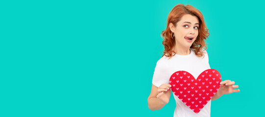 surprised young woman with red heart on blue background. Woman isolated face portrait, banner with...