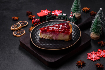 Homemade tasty cheesecake with jelly and raspberry berries on a black plate