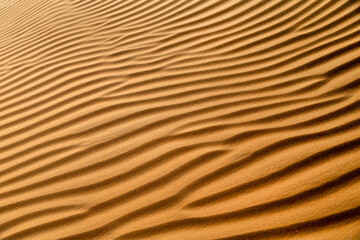 Natural pattern closeup of the sand dune in the desert in Abu Dhabi. Diagonal abstract texture.
