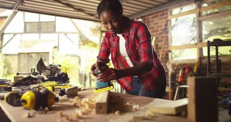 African American female artisan working intently in her workshop - Powered by Adobe
