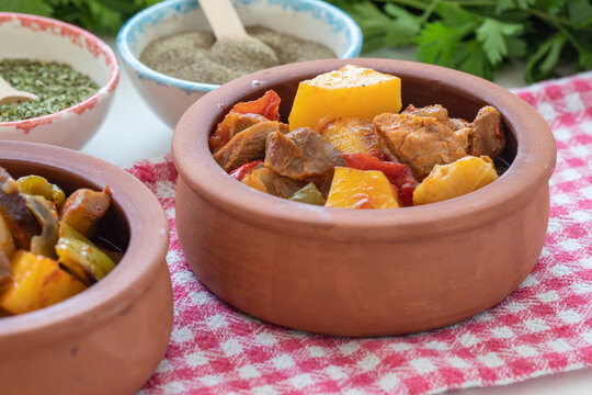 Top view of Turkish food Guvec - meat with vegetables in the oven and traditionally served in a pot (Turkish name; guvec with meat and vegetables)