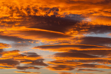 Naklejka na ściany i meble Sky with spectacular lenticular clouds at dawn