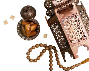 Date fruits in ornamental bowl with prayer beads.