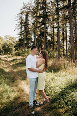 August 28, 2022. Vinnytsia, Ukraine: A couple in love look into each other's eyes and walk in a pine forest