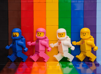 Obraz premium Tambov, Russian Federation - November 07, 2022 Four Lego astronaut minifigures walking in front of a rainbow backdrop