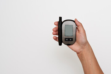 someone holding their cell phone in one hand and pointing at it with the other hand, on a white...