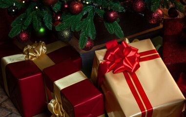 Several gift boxes lie under a decorated Christmas tree.....