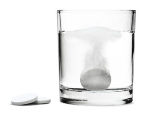 Glass with water and white medical pill