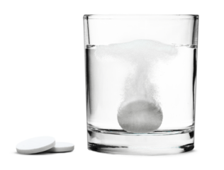 Glass with water and white medical pill