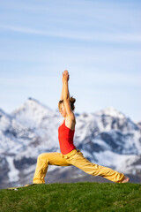 Woman doing yoga in the Alps