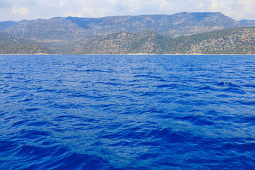 View of the rocky shore from the sea. Mediterranean Sea in Turkey. Popular tourist places. Background