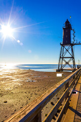 Black lighthouse tower Obererversand Wadden Sea landscape in Dorum Germany.