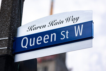 Fototapeta premium Queen Street West, Karen Kain Way, street sign in downtown Toronto, Ontario, Canada