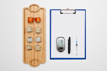 food on a cutting board and a clipboard with a pen next to it that has been cut into pieces