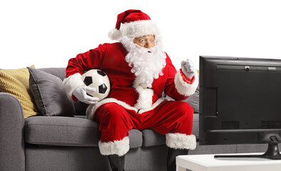 Santa claus watching football on tv and cheering
