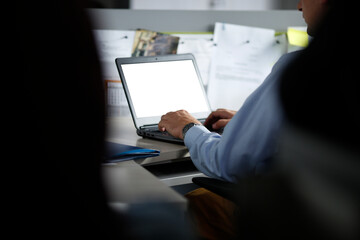 Businessman typing on laptop at work