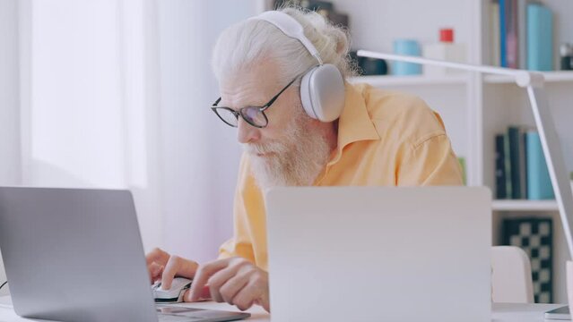 Contemporary grandpa playing multiplayer video game with friends online, hobby 