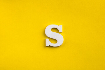 letter S uppercase - white wood letter on yellow color background