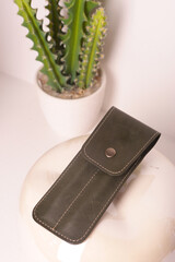 brown leather pen case for two pen closeup photo on white interior background