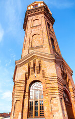 Old brick water tower against the sky in Staraya Russa, Russia