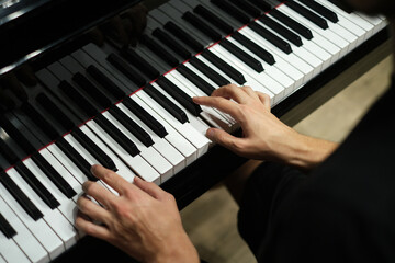 hands of a man playing the piano close-up