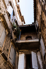 Streets with old buildings and the logo of Hajduk split football club in the old town of Trogir., Croatia.