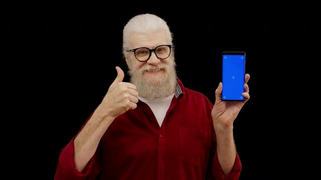Senior man showing smartphone with pre-keyed screen and thumbs-up, app promotion