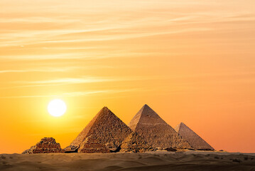 Fototapeta na wymiar The Pyramids in Egypt sunset sky background with copy space