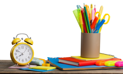 Colored school supplies on wooden table