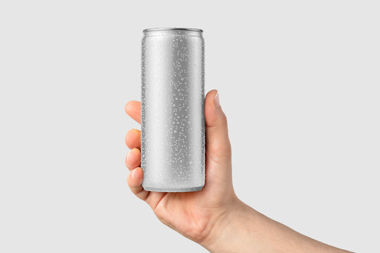 Aluminium drink can 250ml with water drops in a hand mockup template, isolated on light grey background. High resolution.