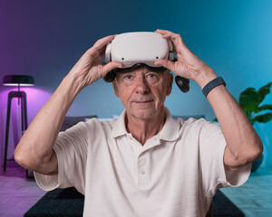 Senior man finished watching entertainment in VR headset