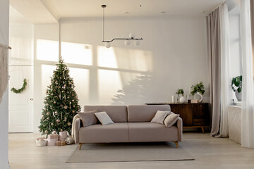 New Year's festive interior with a beige sofa chest of drawers and a Christmas tree
