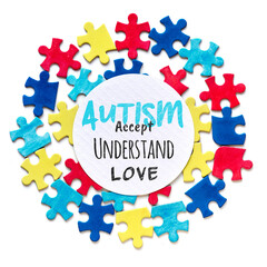 Autism Awareness campaign. Text, Accept, Understand, Love in round circle frame with puzzle pieces...