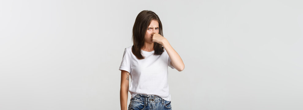 Disgusted Woman Shut Nose And Looking Bothered With Nasty Reek, Bad Smell