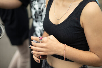 Obraz premium Girl hand. Summer clothes. Bare shoulder. Student holds something in her hand.