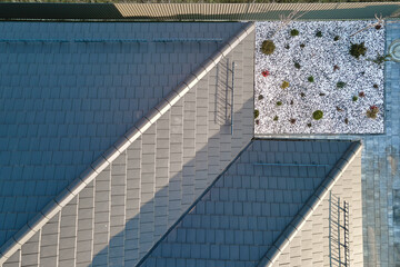 Closeup of house roof top covered with ceramic shingles. Tiled covering of building