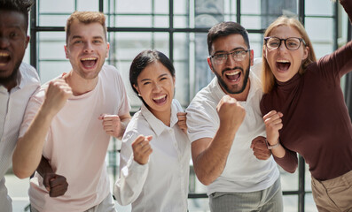 Portrait of successful creative business team looking at camera and smiling.