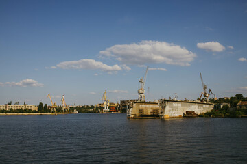 Fototapeta na wymiar Mykolaiv, Ukraine - . September 4, 2021. Cranes in the port where ships can be repaired. View from the riverside