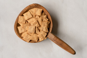 Cauliflower Crackers on a Wood Paddle