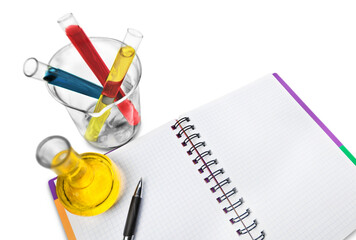 Test tubes with colorful liquids and blank paper